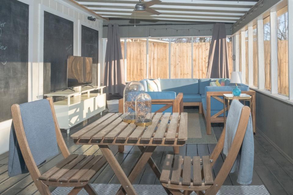 The roomy screened-in porch looks out on the home's nearly half-acre yard.