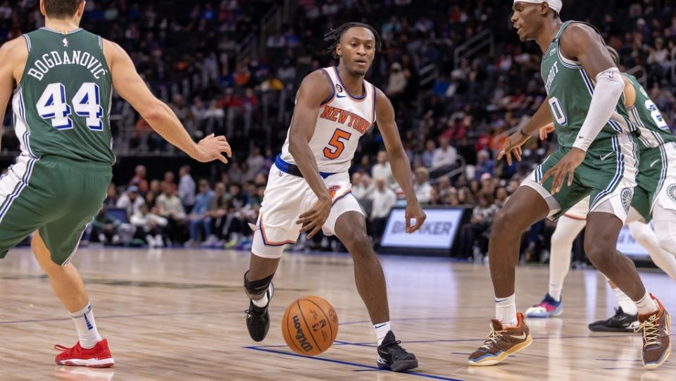 Nov 29, 2022; Detroit, Michigan, USA; New York Knicks guard Immanuel Quickley (5) drives to the basket between Detroit Pistons center Jalen Duren (0) and Bojan Bogdanovic (44)during the first quarter at Little Caesars Arena.