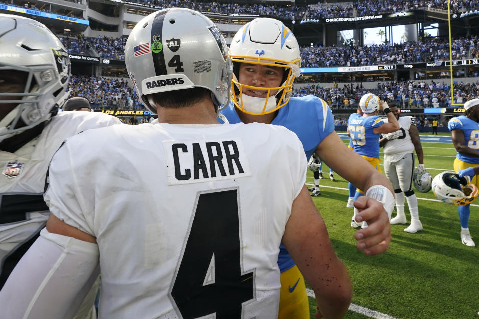 Las Vegas Raiders quarterback Derek Carr (4) greets Los Angeles Chargers quarterback Justin Herbert after an NFL football game in Inglewood, Calif., Sunday, Sept. 11, 2022. (AP Photo/Gregory Bull)