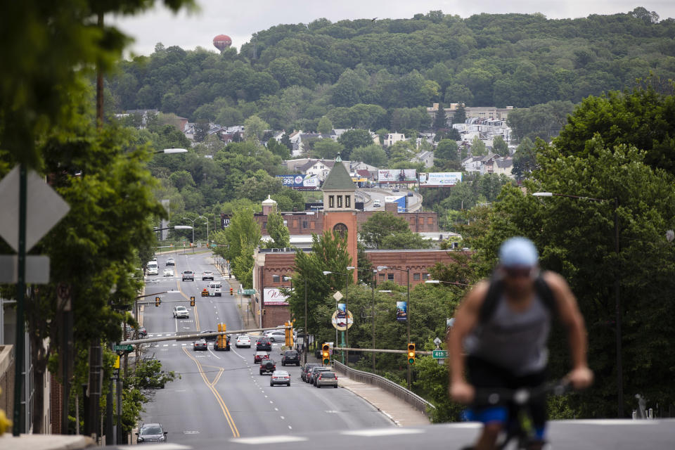 A cyclist pedals up a hill in Allentown, Pa., Friday, May 29, 2020. Allentown predicts a budget deficit of over $10 million, a number officials say could go higher if the economy doesn’t rebound quickly. (AP Photo/Matt Rourke) (AP Photo/Matt Rourke)