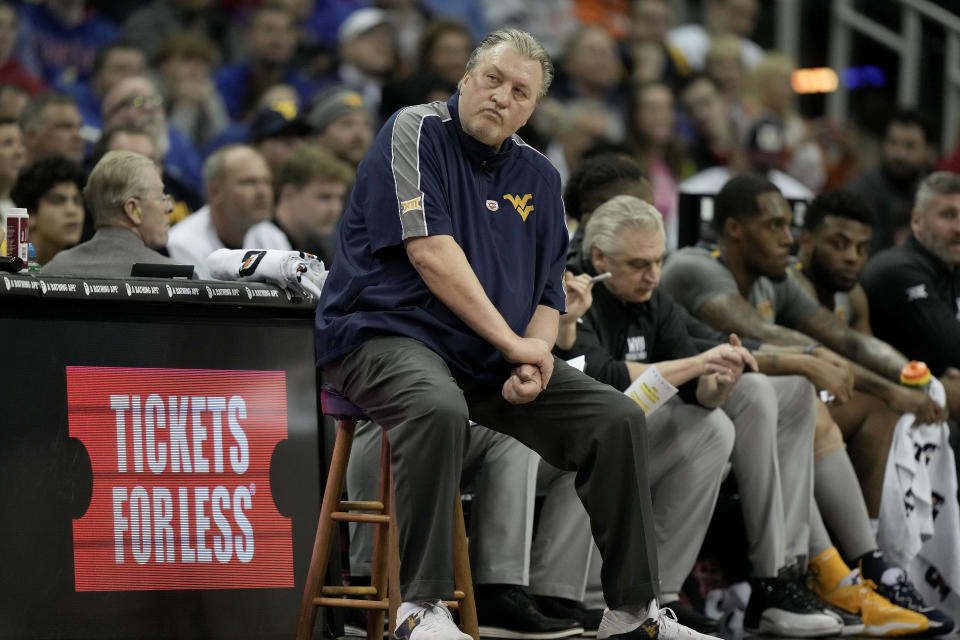 West Virginia head coach Bob Huggins watches during the first half of an NCAA college basketball game against Kansas in the second round of the Big 12 Conference tournament Thursday, March 9, 2023, in Kansas City, Mo. (AP Photo/Charlie Riedel)