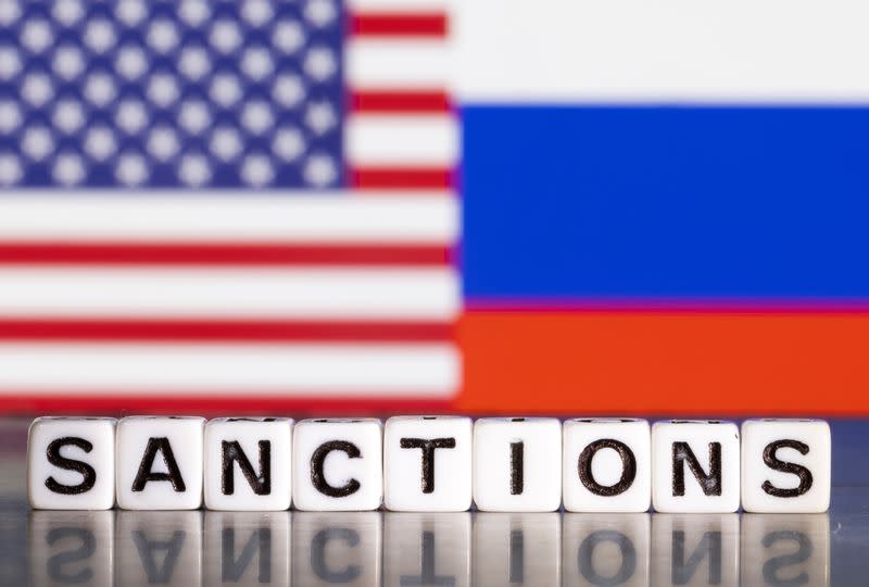 FILE PHOTO: Illustration shows letters arranged to read "Sanctions" in front of flag colors of U.S. and Russia