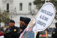 Riot Police stand next to a sign that reads: 'Until judging the last corrupt' during a protest to support Peru's President Martin Vizcarra after he asked the Congress for a new vote of confidence in his Cabinet in Lima, Peru September 18, 2018. REUTERS/Guadalupe Pardo