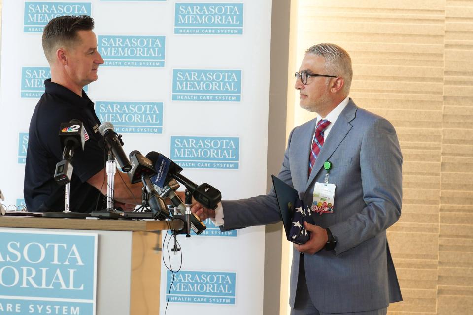 U.S. Rep. Greg Steube, R-Sarasota, left, presented a U.S flag that flew atop the Capitol, a certificate of Congressional excellence and one of his personal Congressional challenge coins to Dr. Ali Al-Rawi, the medical director at Sarasota Memorial Hospital’s Level II Trauma Center, as part of a thank you to the trauma center staff for the care he received after falling off a 25-foot-tall ladder while trimming a tree branch last month.