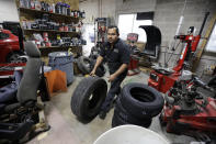In this Nov. 22, 2019, photo, mechanic Miguel Borrayo works on a car in Ogden, Utah. Borrayo tried to find a lawyer to help him argue he should be allowed to stay in the country with his American-born children, despite lacking legal papers. But he was told it would cost up to $8,000 and he didn’t have a strong case. He was given a month to leave the country. (AP Photo/Rick Bowmer)