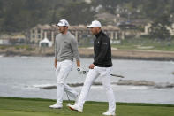 Patrick Cantlay, left, and Daniel Berger walk up to the sixth green of the Pebble Beach Golf Links during the final round of the AT&T Pebble Beach Pro-Am golf tournament Sunday, Feb. 14, 2021, in Pebble Beach, Calif. (AP Photo/Eric Risberg)