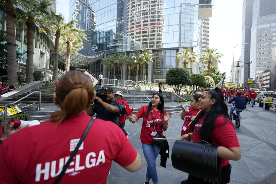 Striking hotel workers rally outside the Intercontinental Hotel after walking off their job early Sunday, July 2, 2023, in downtown Los Angeles. (AP Photo/Damian Dovarganes)