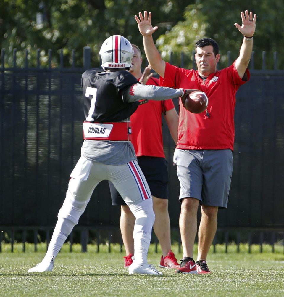 Ryan Day works with quarterback Dwayne Haskins during a practice in 2018.