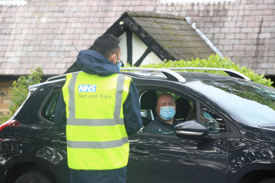 A member of staff speaking to a man (permission given) arriving at working at a Coronavirus testing centre at the Last Drop Village Hotel in Bolton.