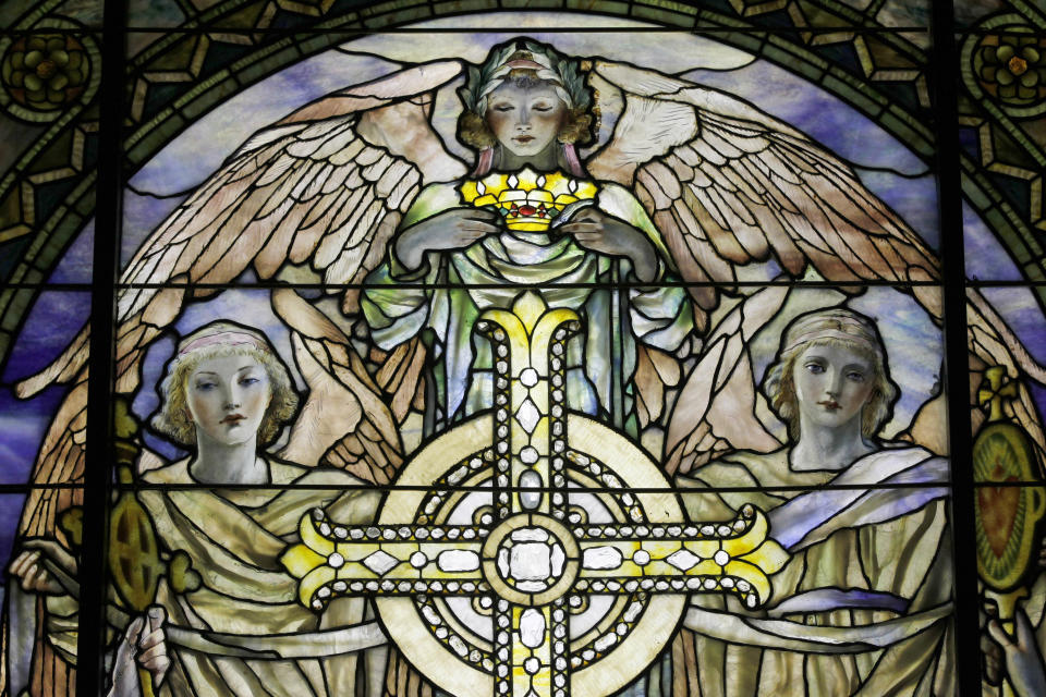 In this Thursday, Oct. 25 2012 photo, a detail of "The Righteous Shall Receive a Crown of Glory," Brainard Memorial Window for Methodist Church, Waterville, New York, ca. 1901 is photographed while on display at the "Louis C. Tiffany and the Art of Devotion" exhibit at the Museum of Biblical Art in New York. (AP Photo/Mary Altaffer)