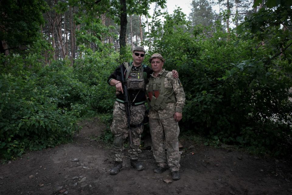 Father Vasyl (R) and son "Pitbull" pose for a portrait at a training camp in southeastern Ukraine on May 22, 2023. (Francis Farrell/The Kyiv Independent)