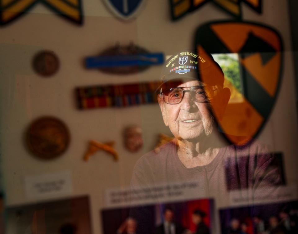 Robert Shipe is reflected in a shadow box of his mementoes from his service in the U.S. Army during World War II, seen in his Palm Springs home on May 15, 2024.