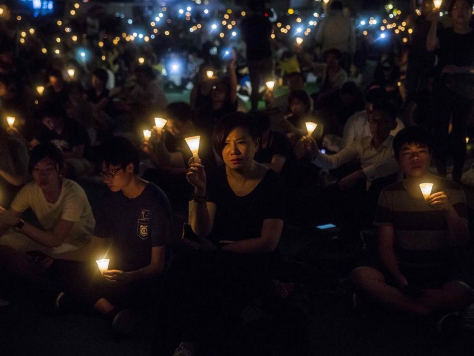People holding candles during a vigil in Hong Kong to mark the 30th anniversary of the 1989 Tiananmen crackdown: AFP via Getty Images