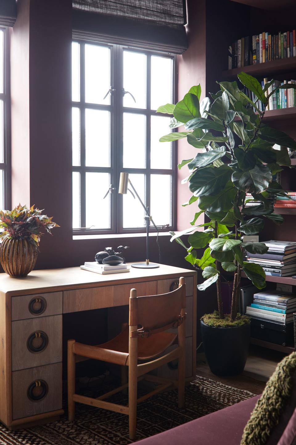 In the home office, the oak desk with bronze hardware was designed by Teresa Hastings, and the desk chair is by Danish furniture designer Børge Mogensen. The bronze objects are Liaigre. The rug is Gabbeh tribal, and the daybed is covered in Kvadrat velvet.