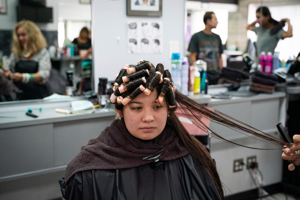 Emilie Nieves, 19, of Allen Park, has her hair permed for the first time at Anthony's Hair Inc in Allen Park on July 25, 2023. "I think it will be a cute summer look," said Nieves, who was looking forward to trying something new.