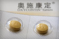 This Sept. 24, 2019 photo shows 40-milligram OxyContin tablets sold in China in Hunan province. OxyContin's U.S. FDA-approved label warns that even if taken as prescribed, the opioid carries potentially lethal risks of addiction and abuse. (AP Photo/Mark Schiefelbein)
