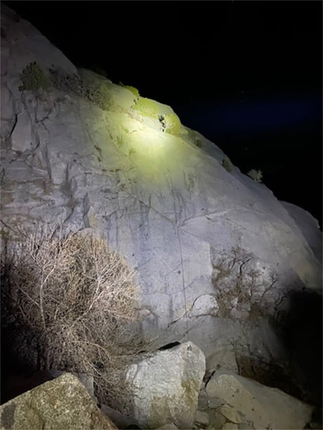 A rescue team with the Salt Lake County Sheriff's Search and Rescue shine a high-powered light to help climbers descend safely in Little Cottonwood Canyon, Utah, on April 9, 2021. (Salt Lake County Sheriff's Search and Rescue via Facebook)