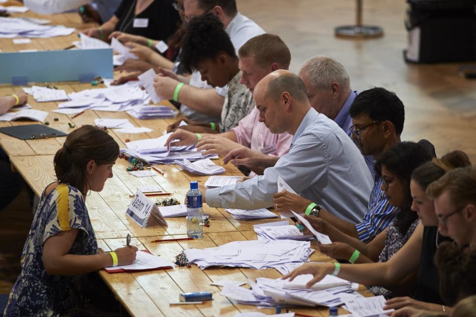Vote counting staff sort ballot papers at a vote counting centre at The Royal Horticultural Halls in central London on June 23, 2016. Voting has ended in Thursday's historic British referendum on EU membership, with the final opinion poll pointing to a slender victory for the 'Remain' campaign.&nbsp;