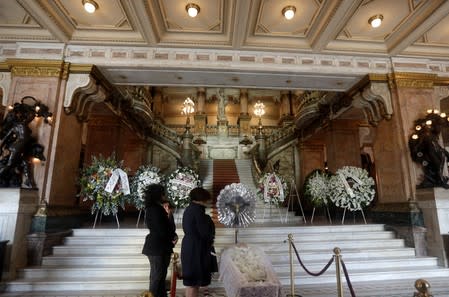 Relatives react during the wake of Brazilian singer Joao Gilberto in Rio de Janeiro's Municipal Theater