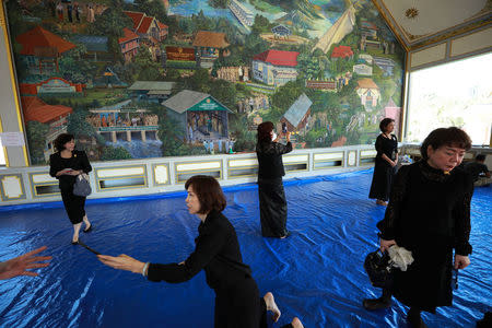 Visitors take pictures in front of a painted wall inside the Royal Crematorium for the late King Bhumibol Adulyadej in Bangkok, Thailand, September 19, 2017. REUTERS/Athit Perawongmetha