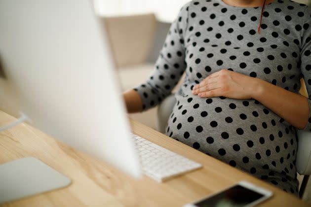 Two women shared that they kept their pregnancies hidden for as long as they could, out of fear that they'd be penalized at their job if found out. (Photo: damircudic via Getty Images)