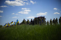 Ukrainian soldiers carry the coffin of Volodymyr Losev, 38, during his funeral in Zorya Truda, Odesa region, Ukraine, Monday, May 16, 2022. Volodymyr Losev, a Ukrainian volunteer soldier, was killed May 7 when the military vehicle he was driving ran over a mine in eastern Ukraine. (AP Photo/Francisco Seco)