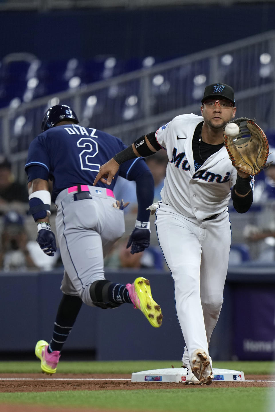 Tampa Bay Rays' Yandy Diaz (2) beats out the throw to Miami Marlins first baseman Yuli Gurriel for a base hit during the first inning of a baseball game, Tuesday, Aug. 29, 2023, in Miami. (AP Photo/Wilfredo Lee)