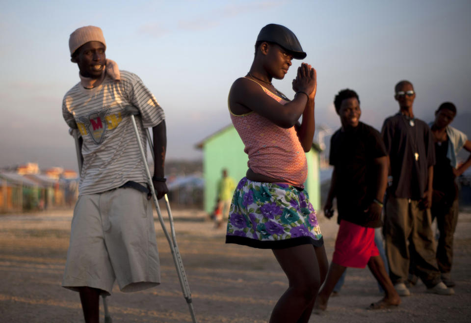 In this picture taken on Feb. 10, 2012, a hearing impaired dancer rehearses her steps for an upcoming performance, at La Piste camp in Port-au-Prince, Haiti. While more than a million people displaced by the 2010 quake ended up in post-apocalyptic-like tent cities, some of the homeless people with disabilities landed in the near-model community of La Piste, a settlement of plywood shelters along tidy gravel lanes. However, the rare respite for the estimated 500-plus people living at the camp is coming to an end as the government moves to reclaim the land. (AP Photo/Ramon Espinosa)