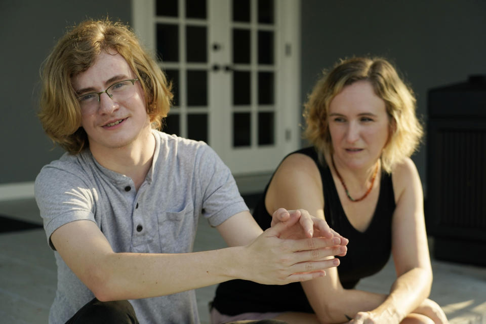 Ray Walker, 17, left, speaks about his acceptance of having to move out-of-state for continued gender-affirming care, while his mother Katie Rives, listens, Wednesday, June 28, 2023, in Madison County, Miss. This year, Republican Gov. Tate Reeves signed legislation banning gender-affirming care for anyone younger than 18. (AP Photo/Rogelio V. Solis)