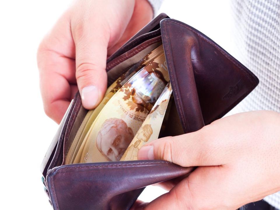 Man Counting Money in his Wallet