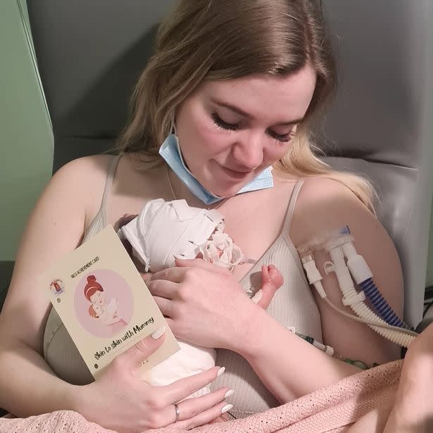 Lucy holding Nina in hospital.