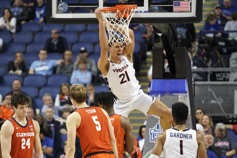 Virginia forward Kadin Shedrick (21) reacts after dunking against Clemson during the second half of an NCAA college basketball game at the Atlantic Coast Conference Tournament in Greensboro, N.C., Friday, March 10, 2023. (AP Photo/Chuck Burton)