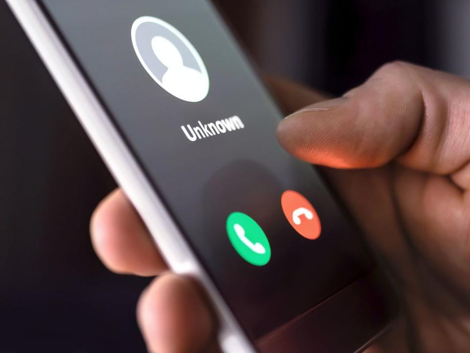 Phone call from unknown number late at night. Scam, fraud or phishing with smartphone concept. Prank caller, scammer or stranger. Man answering to incoming call.