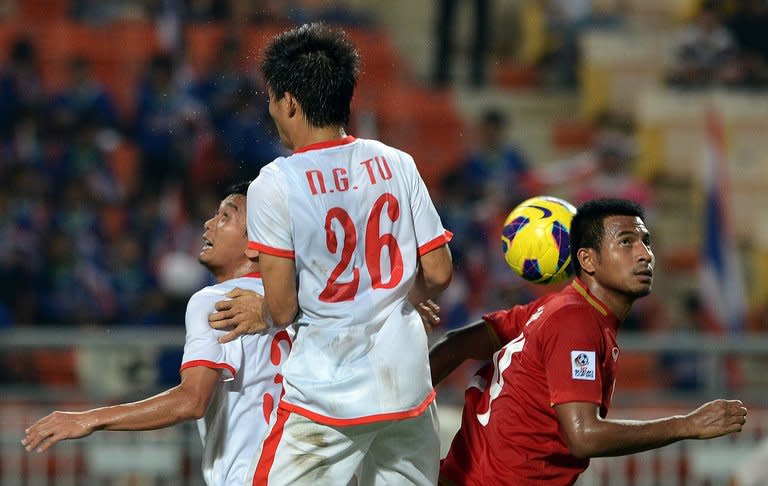 Thailand's Sompong Soleb (R) battles with Vietnam's Nguyen Gia Tu during their AFF Suzuki Cup final group match in Bangkok on November 30. Thailand defeated Vietnam 3-1 to sweep into the semi-finals but the "War Elephants" face a stern test against Malaysia