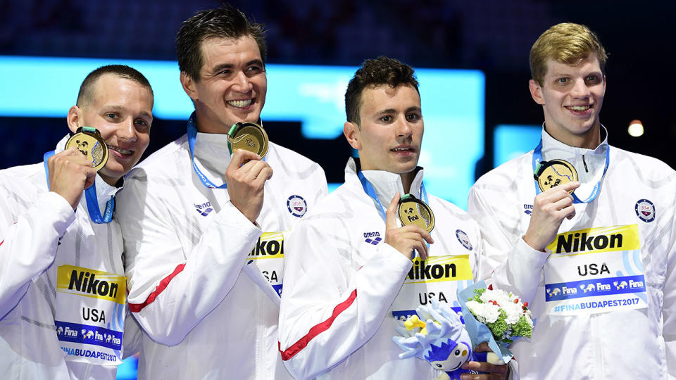 Gold medallists (L-R) US swimmer Caeleb Dressel, Blake Pieroni, Zachary Apple and Nathan Adrian pose on the podium of the 400m Free Relay men final of the Pan Pacific Swimming Championships 2018 in Tokyo, they were later disqualified. (Photo by Martin BUREAU / AFP) (Photo credit should read MARTIN BUREAU/AFP/Getty Images)