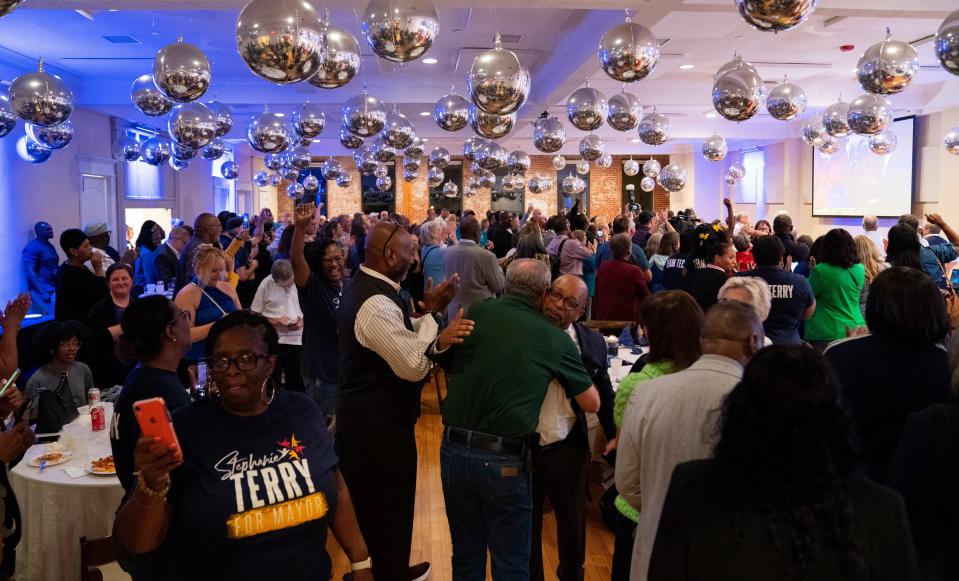 The crowd cheers as results come in during a democratic election watch party at City View at Sterling Square in Evansville, Ind., Tuesday, Nov. 7, 2023.