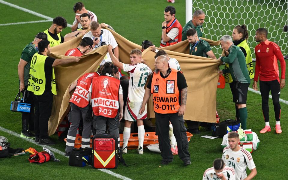 Hungary's Barnabas Varga receives medical attention after sustaining an injury