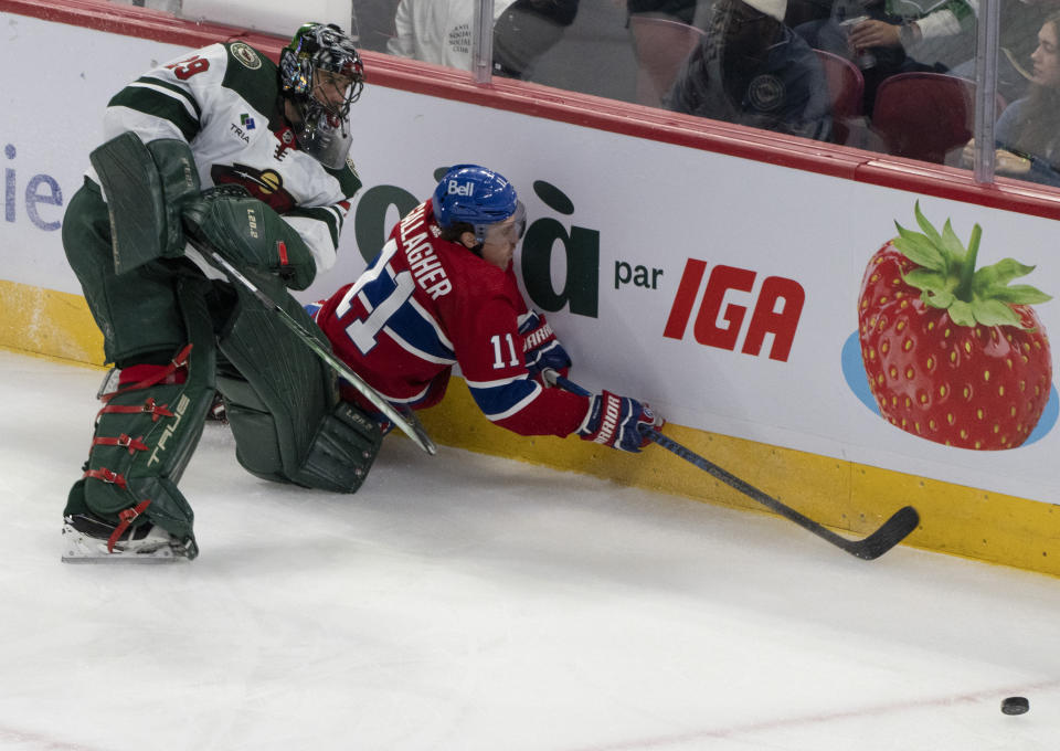 Montreal Canadiens' Brendan Gallagher (11) battles for the puck against Minnesota Wild goaltender Marc-Andre Fleury (29) during the second period of an NHL hockey game, Tuesday, Oct. 17, 2023 in Montreal. (Christinne Muschi/The Canadian Press via AP)
