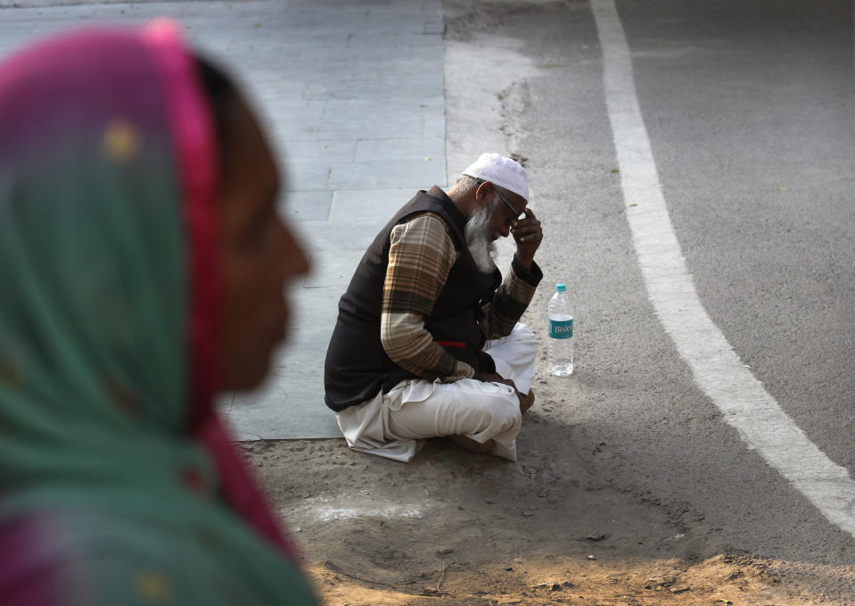 An elderly Indian Muslim waits to receive the body of a relative who died in a fire, at a mortuary in New Delhi, India, Sunday, Dec. 8, 2019. Dozens of people died on Sunday in a devastating fire at a building in a crowded grains market area in central New Delhi, police said. (AP Photo/Manish Swarup)