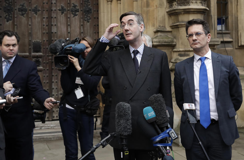 Pro-Brexit, Conservative lawmaker Jacob Rees-Mogg, second right, gestures as he speaks to the media outside the Houses of Parliament in London, Thursday, Nov. 15, 2018. A pro-Brexit group of Conservative lawmakers says one of its leaders, Jacob Rees-Mogg, is formally calling for a vote of no-confidence in Prime Minister Theresa May. Two British Cabinet ministers, including Brexit Secretary Dominic Raab, resigned Thursday in opposition to the divorce deal struck by Prime Minister Theresa May with the EU — a major blow to her authority and her ability to get the deal through Parliament.(AP Photo/Matt Dunham)