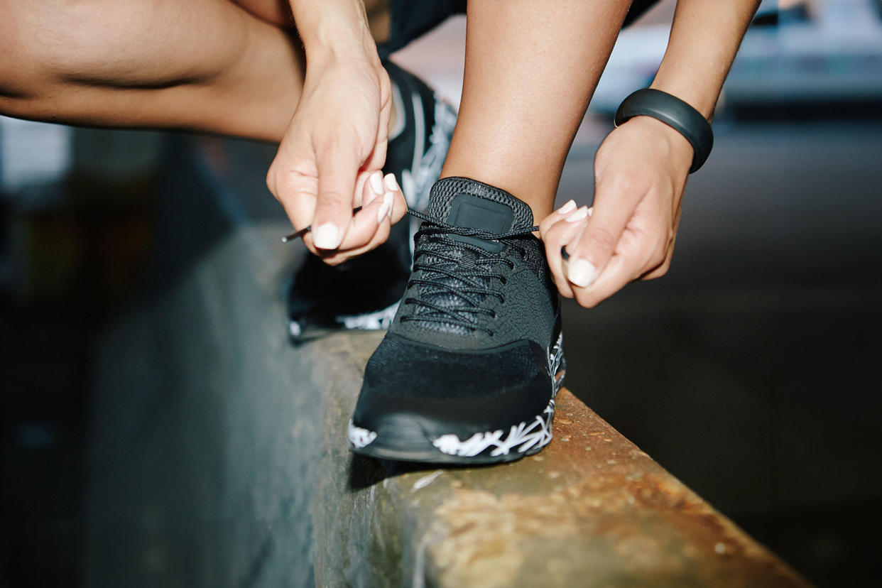 Woman tying running shoes Getty Images/BROOK PIFER
