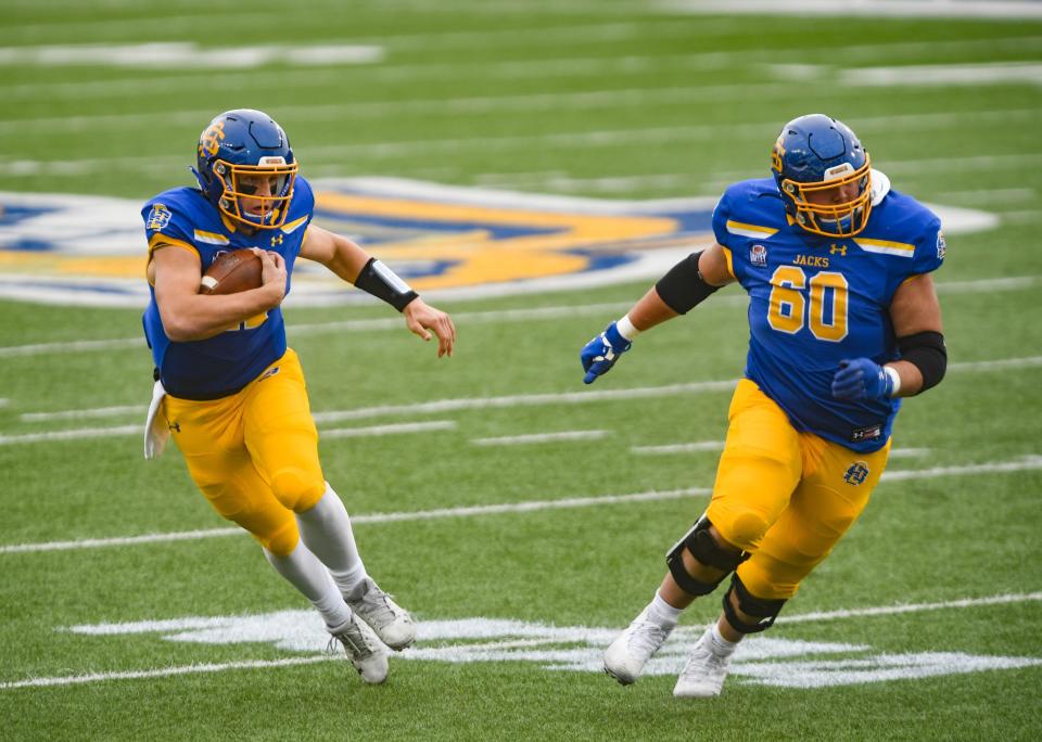 South Dakota State’s <a class="link " href="https://sports.yahoo.com/ncaaf/players/320416/" data-i13n="sec:content-canvas;subsec:anchor_text;elm:context_link" data-ylk="slk:Mark Gronowski;sec:content-canvas;subsec:anchor_text;elm:context_link;itc:0">Mark Gronowski</a> runs with the ball alongside Mason McCormick during the FCS semifinals against <a class="link " href="https://sports.yahoo.com/ncaaf/teams/delaware/" data-i13n="sec:content-canvas;subsec:anchor_text;elm:context_link" data-ylk="slk:Delaware;sec:content-canvas;subsec:anchor_text;elm:context_link;itc:0">Delaware</a> on Saturday, May 8, 2021 at Dana J. Dykhouse stadium in Brookings.<br>Sdsu Semifinals 020