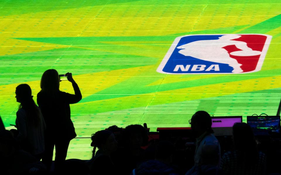 The NBA’s new LED basketball court, which will debut during the NBA All-Star games in Indianapolis, is tested Thursday, Feb. 15, 2024 at Lucas Oil Stadium. The court display can instantly change from the regular basketball court the players are on to a variety of graphic visuals.