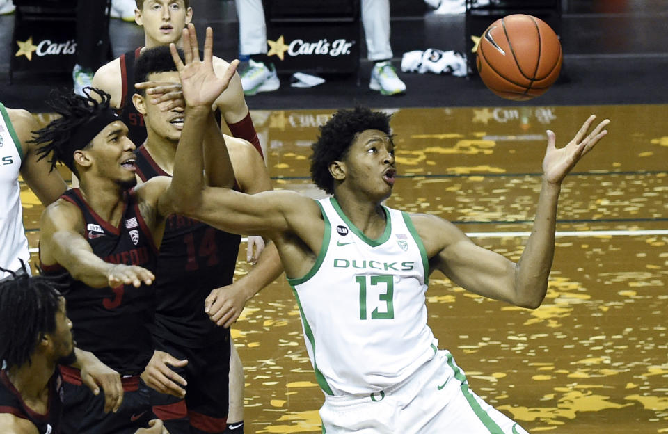 Oregon forward Chandler Lawson (13) tries to grab a loose ball as Stanford forward Ziaire Williams (3) comes into the play during the second half of an NCAA college basketball game Saturday, Jan. 2, 2021 in Eugene, Ore. Oregon won the game 73-56. (AP Photo/Andy Nelson)