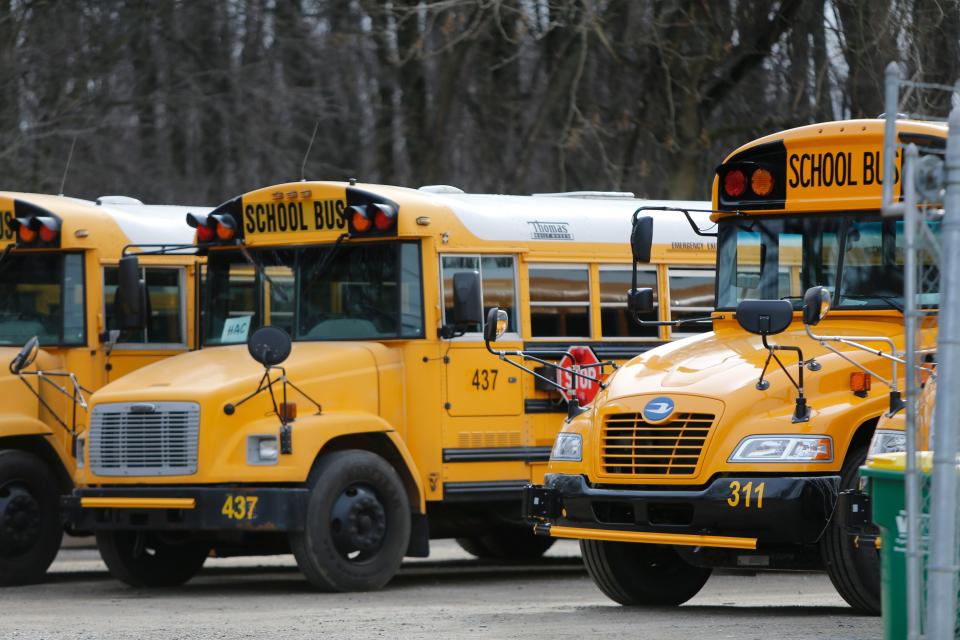 Red Clay School District buses sit in a bus yard in New Castle.