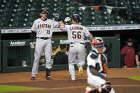 Arizona Diamondbacks' Kole Calhoun (56) celebrates with Nick Ahmed (13) after hitting a home run against the Houston Astros during the eighth inning of a baseball game Friday, Sept. 18, 2020, in Houston. (AP Photo/David J. Phillip)