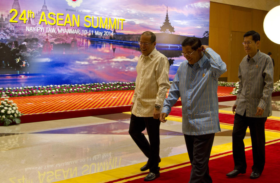 Philippines President Benigno "Noynoy" Aquino III, left, Cambodian Prime minister Hun Sen, center, and Thailand ministry of Foreign Affaires, permanent secretary Sihasak Phuangketkeow, right walk after posing for a picture during 24th Association of Southeast Asian Nations Summit in Naypyitaw, Myanmar, Saturday, May 10 2014. (AP Photo/Gemunu Amarasinghe)