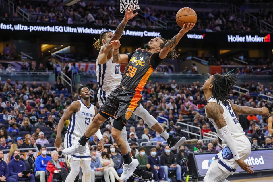 Feb 5, 2022; Orlando, Florida, USA; Orlando Magic guard Cole Anthony (50) goes to the basket against Memphis Grizzlies forward Brandon Clarke (15) during the second quarter at Amway Center. Mandatory Credit: Mike Watters-USA TODAY Sports