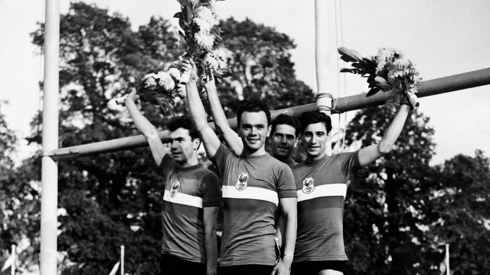 Fernand Decanali, Pierre Adam, Serge Blusson and Charles Coste stand atop the podium at the 1948 Olympics. - AFP/Getty Images