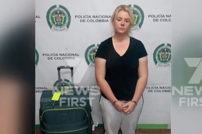 Australian Cassandra Sainsbury in handcuffs after she was arrested at the international airport in Bogota. Source: 7 News